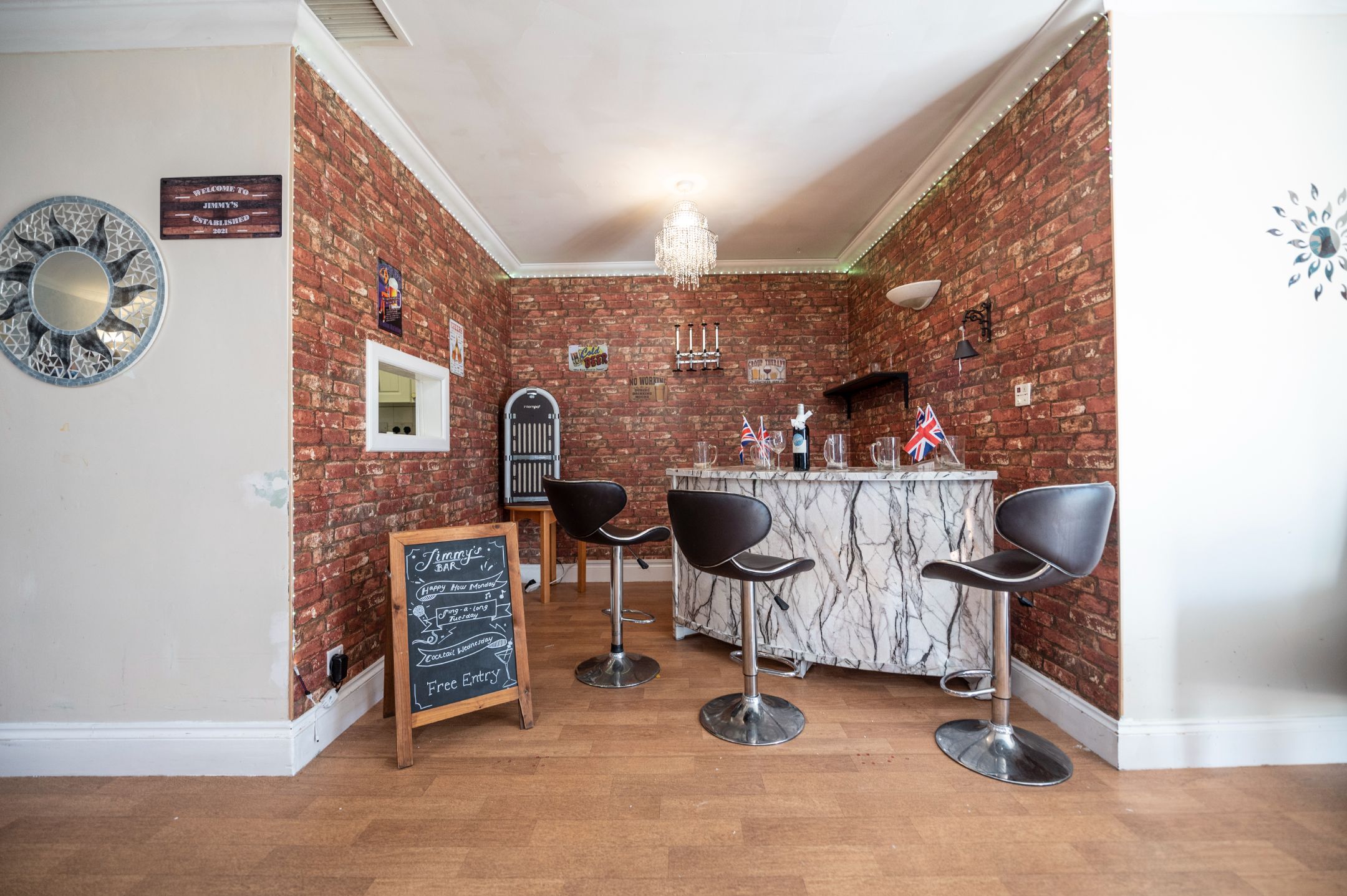 Small in-house bar with a vintage feel, featuring brick walls and bar stools.