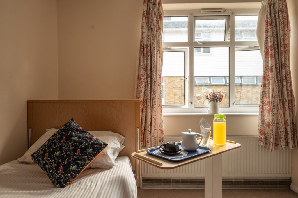 Bedroom with bedside table within a care home