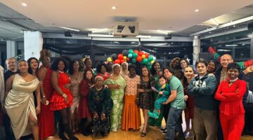 Residents and staff of Marlborough Court Care Home celebrate Christmas together, surrounded by festive decorations and balloons.