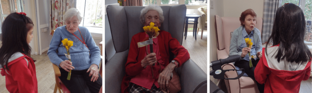 Martins House: Heartwarming Visit from Young Rainbows Children visiting seniors at Martins House, sharing flowers and joy.
