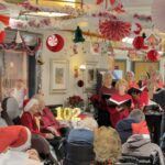 Double Centenary Celebrations at Broxbourne Nursing Home Residents and performers celebrate with festive decor and singing.