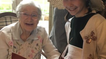 A Magical World Book Day at Hungerford Care Home: Joyful Interaction Between Young Girl and Elderly Resident
