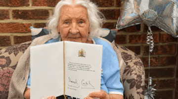 Centenarian resident celebrating 100th birthday with card