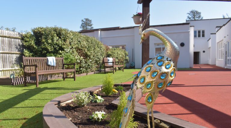 Lynwood Care Centre Garden with Decorative Peacock Sculpture