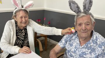 Elderly residents celebrating with bunny ears and toys.