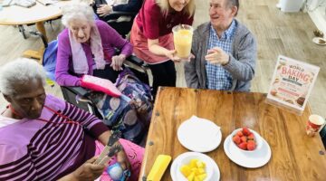 Residents celebrating World Baking Day with drinks and strawberries