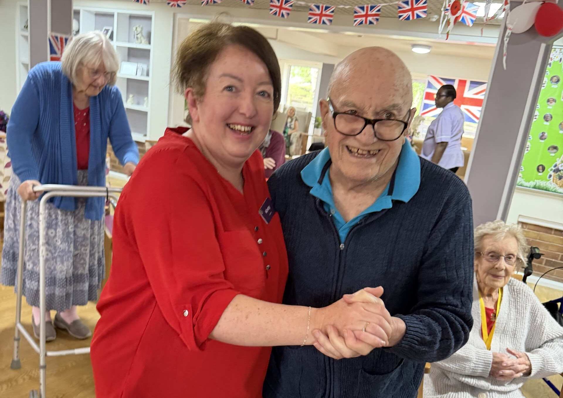 Elderly residents share a joyful VE Day dance at Lucton House