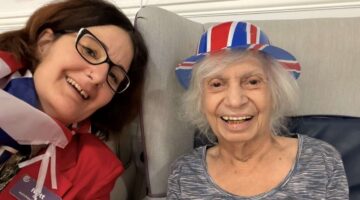 Care worker and resident smiling at VE Day celebrations in Kent House