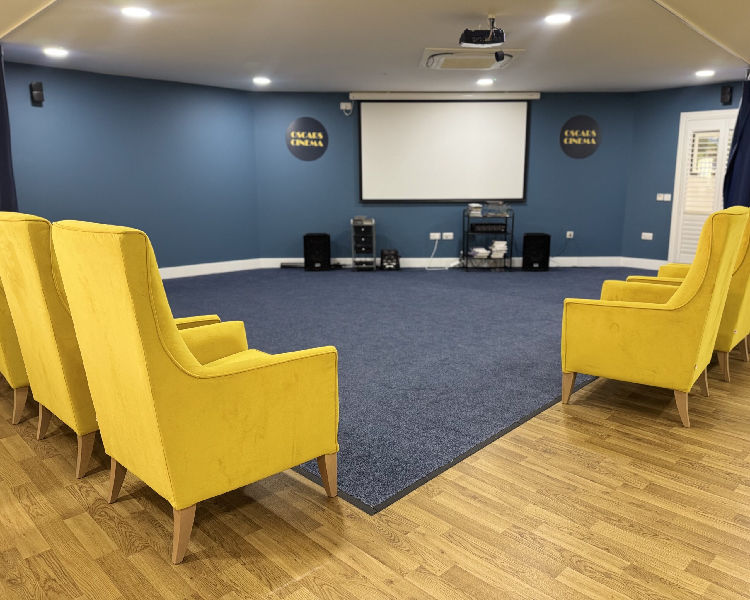 Lynwood Care Centre Activity Room with Yellow Chairs and Screen