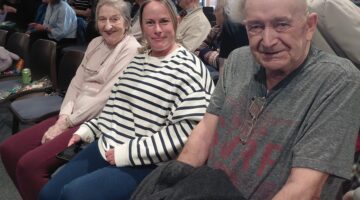 Community Gathering: Three Friends Enjoying a Social Event