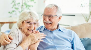 Happy elderly couple planning retirement finances together