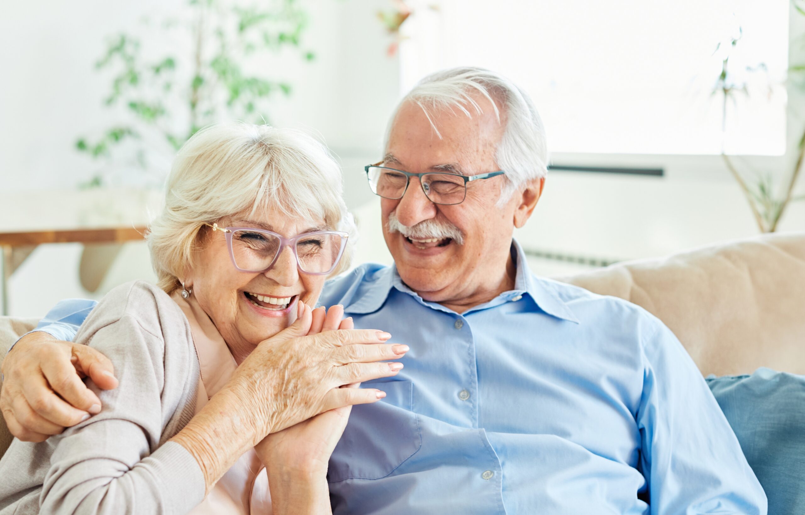 Happy elderly couple planning retirement finances together