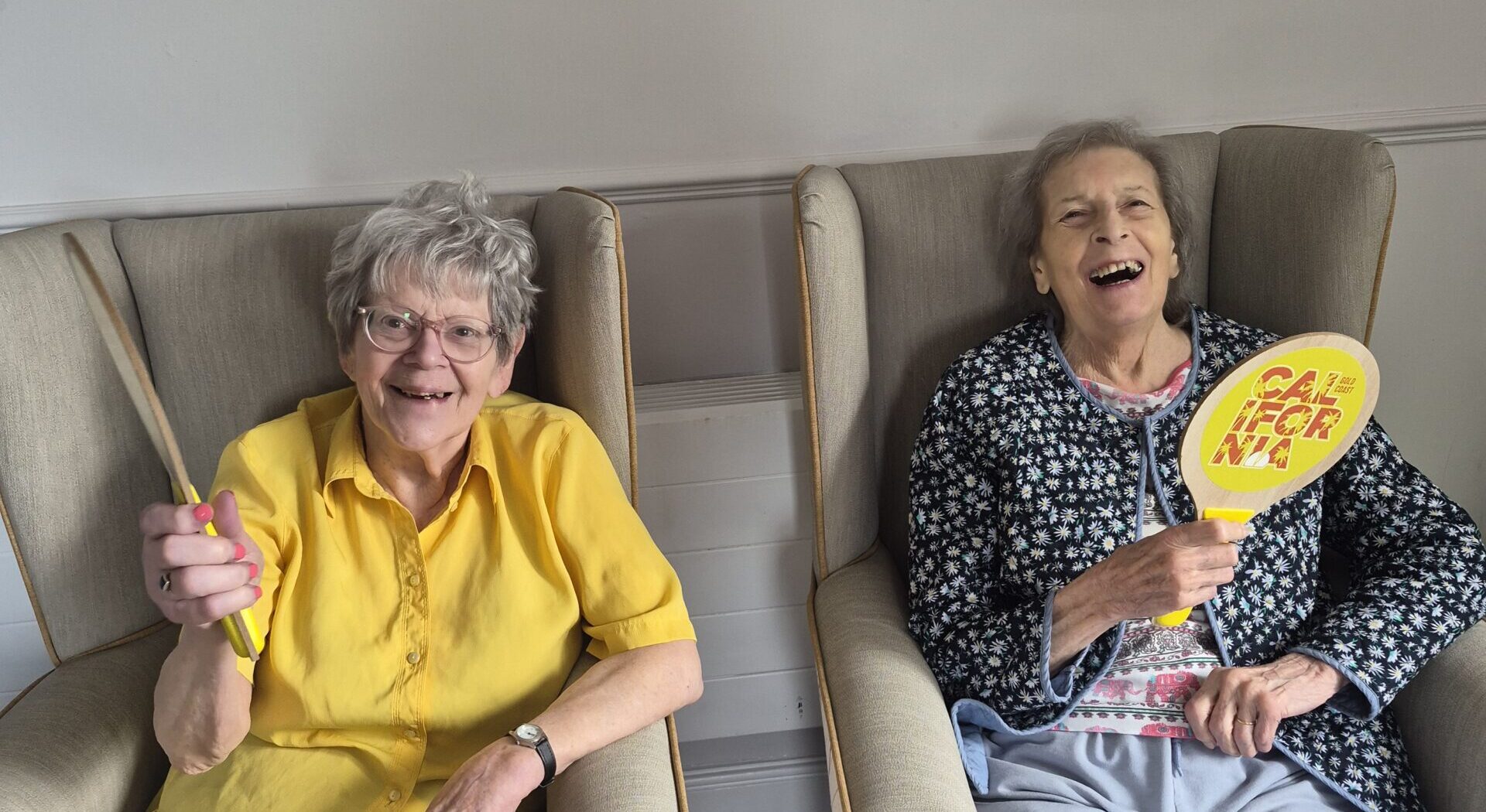 Residents playing tennis with Wimbledon themed rackets at Kingston Care Home