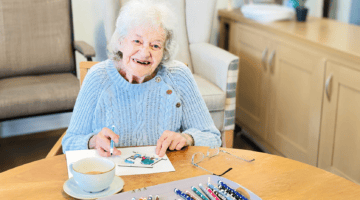 Creative arts session at Kingston House: elderly woman drawing