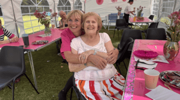 Senior women enjoying birthday party in decorated marquee tent