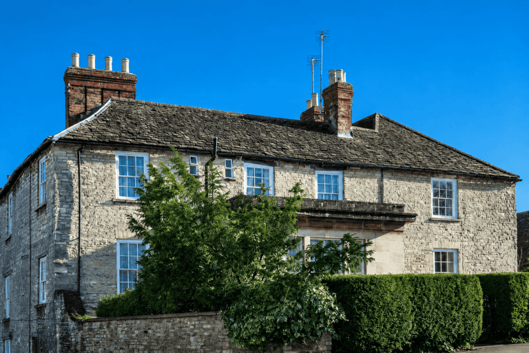 Mill House Care Home exterior stone building under blue sky