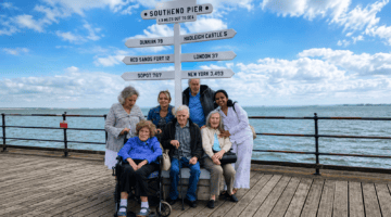 Seaside residents relaxing at Southend Pier under blue skies