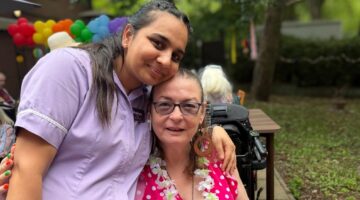 Care staff and resident enjoy Summer Garden Party sunshine