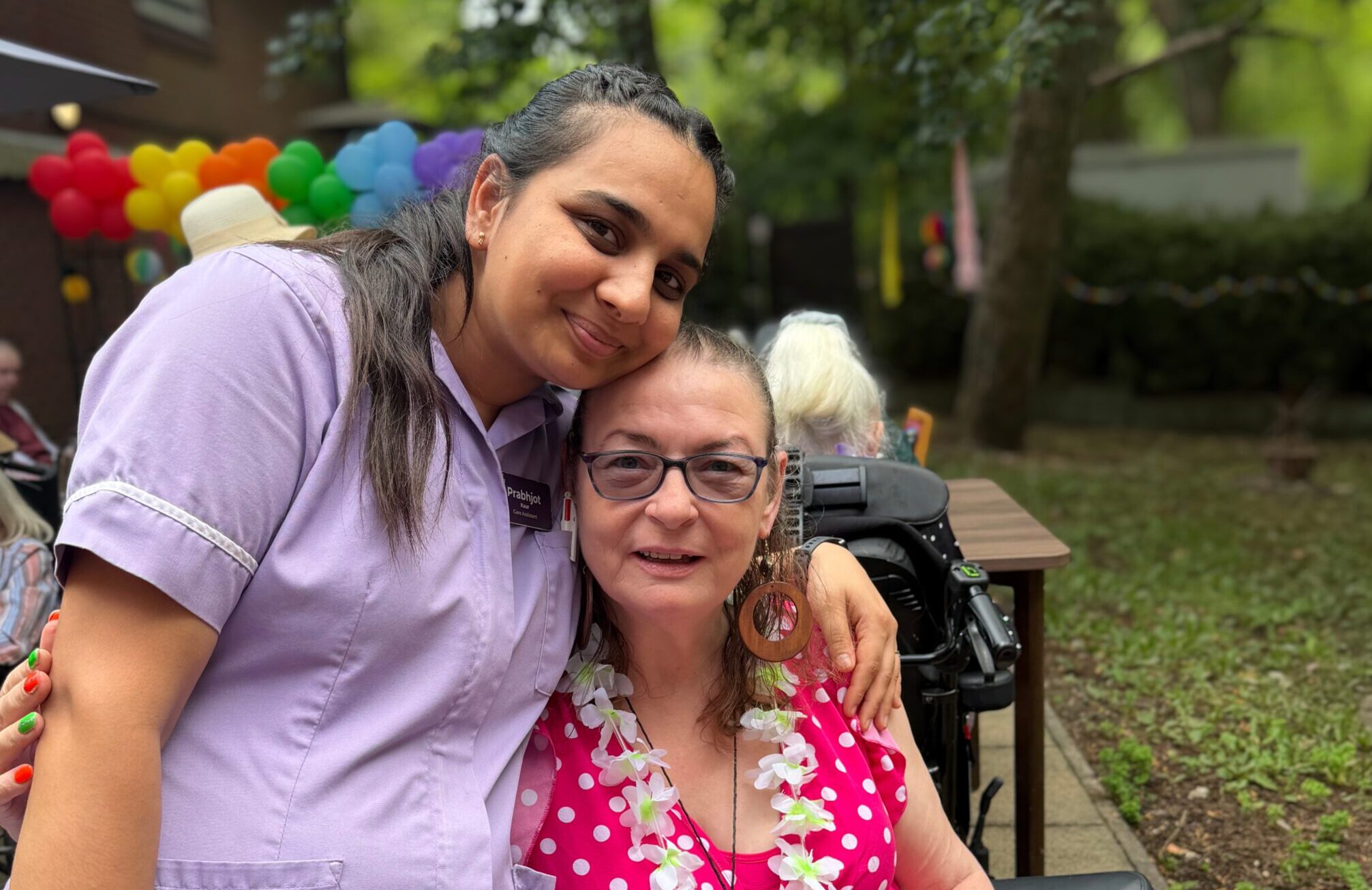 Care staff and resident enjoy Summer Garden Party sunshine