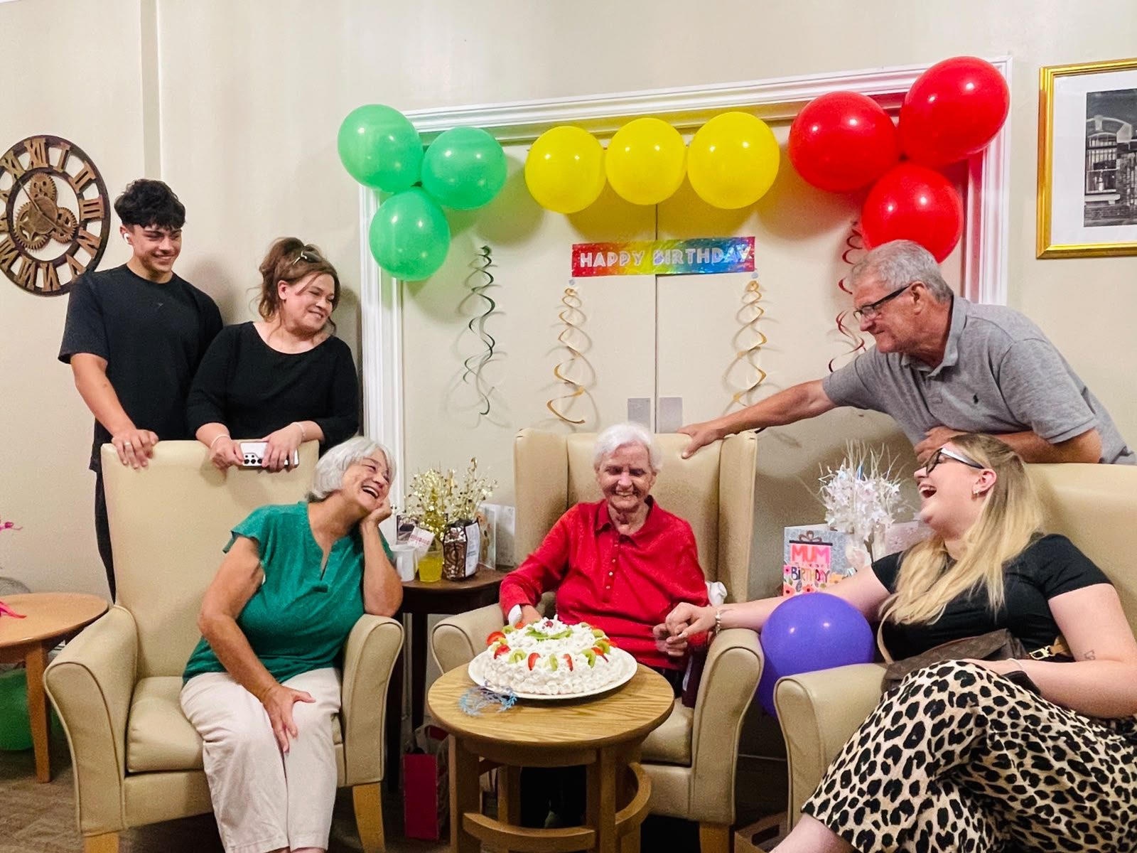 Family birthday celebration with balloons and cake at home