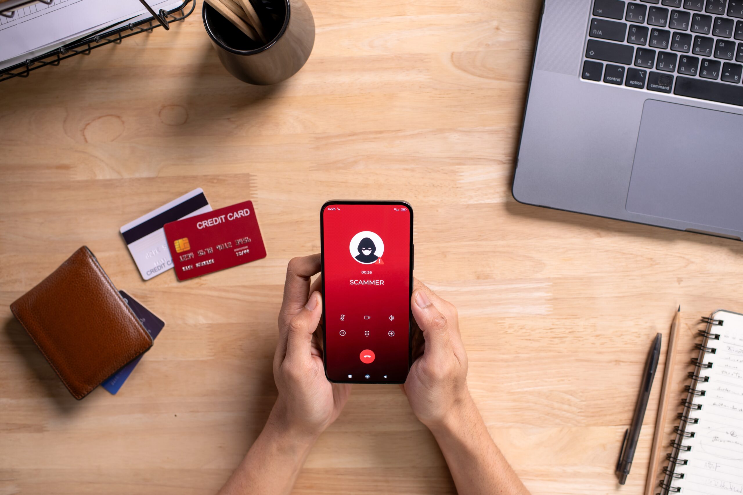Smartphone warning about phone scam with credit cards