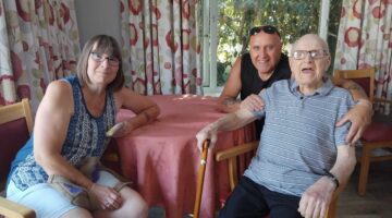 Smiling residents enjoying Martins House summer fete together