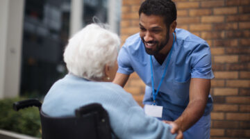 Palliative care nurse offering compassionate support to elderly patient