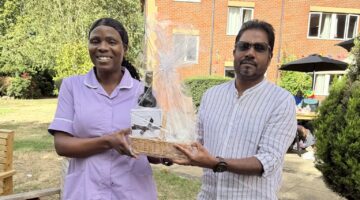 Garden gift basket handover at outdoor community event