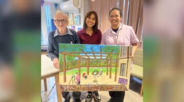 David proudly holds his Serenity artwork at Beachcroft House