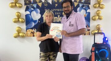 Senior care award celebration with nurse presenting certificate