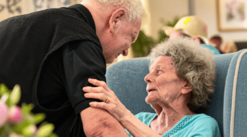Elderly residents sharing a warm embrace at Partridge House