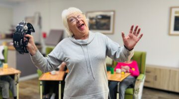 Senior resident dances to music at Queensway House today