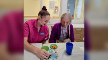 Care worker and resident create mini garden flower designs